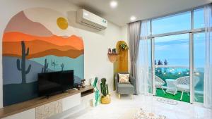 a living room with a television and a view of the ocean at Chang homestay Phan Thiết - Sealink Mũi Né in Phan Thiet