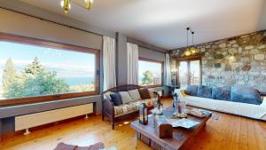 a living room with a couch and a large window at Panorama Villa Sea view in Selianitika +71 photos