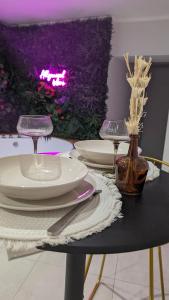 a table with plates and utensils on top at SUITE Roch'amore troglodyte Romantique et Unique in La Garde