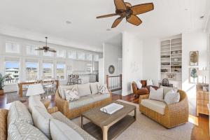 a living room with couches and a ceiling fan at Windansea in Surf City