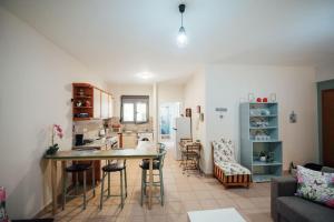 a kitchen and living room with a table and chairs at Dasillion Apartment by Alexia in Igoumenitsa