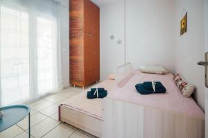 a bedroom with a bed with two bags on it at Dasillion Apartment by Alexia in Igoumenitsa