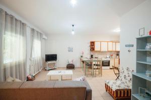 a living room with a couch and a table at Dasillion Apartment by Alexia in Igoumenitsa