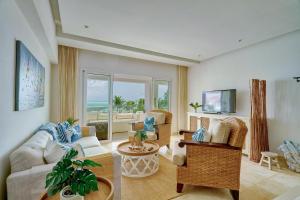 a living room with a couch and a table at Beautiful Modern Condo At Cap Cana, Punta Cana in Punta Cana