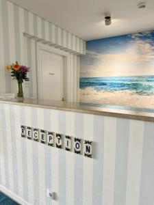 a room with a beach mural on the wall at Ocean View Apartments in Lourinhã