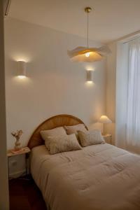 a bedroom with a large white bed with two pillows at Liviamariasanta in Ajaccio +4 photos