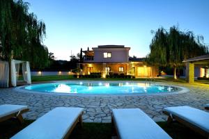 a swimming pool in a yard with a house at Villa Black White Dassia in Dassia