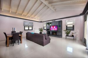 a living room with a couch and a table at Villa Black White Dassia in Dassia