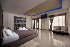 a bedroom with a large bed and a couch at Villa Black White Dassia in Dassia
