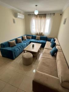 a living room with a large couch and a table at Appartement Sidi Rahal in Sidi Rahal +29 photos