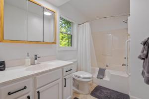 a white bathroom with a sink and a toilet at Friends&fam2min Towngame Roombikes10min Beach in Saugatuck +29 photos