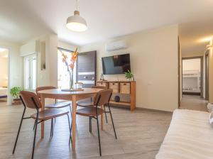 a living room with a table and chairs and a couch at CASA MIRA luxury sea house fco airport in Fiumicino