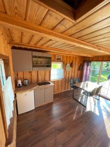 a kitchen and dining room with a table and chairs at Gintaro pirtelė in Lazdijai