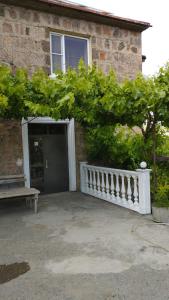 a building with a door and a bench in front of it at Sargsyan Guest House in Areni