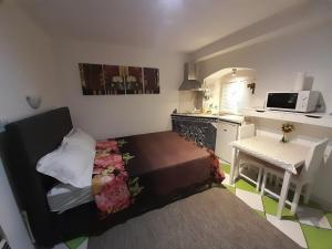 a small room with a bed and a kitchen at Split studio Irisha in Split