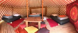 a room with three beds in a yurt at Le Domaine du Trappeur in Saint-Sorlin-dʼArves