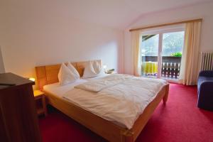 a bedroom with a bed and a large window at Feichterhof in Bad Kleinkirchheim +89 photos