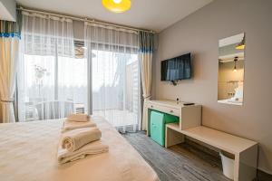 a bedroom with a bed with a desk and a mirror at Nirvana Hotel in Bozcaada