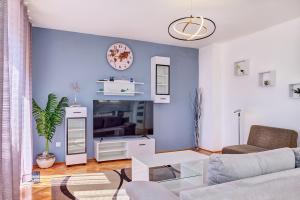 a living room with a couch and a table at Apartman Meri in Cres