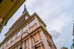 an old building with a clock tower on top of it at Casa Riberi Mole Antonelliana Centro in Turin