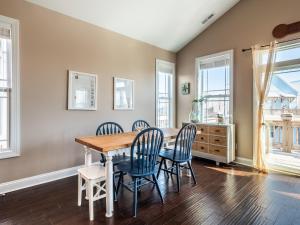 a dining room with a wooden table and chairs at Sundancer in Surf City
