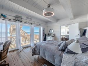 een slaapkamer met een bed en uitzicht op de oceaan bij Vintage Vacation in Surf City