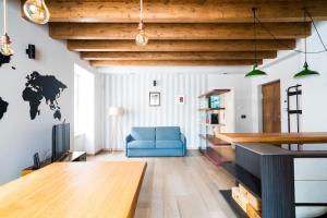 a living room with a blue couch and a table at Casa Riberi Mole Antonelliana Centro in Turin