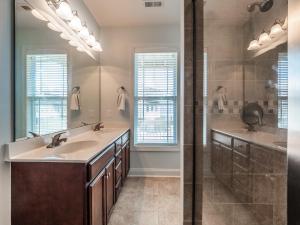 a bathroom with a double sink and a shower at Sundancer in Surf City +48 photos