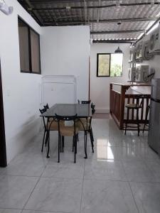 a dining room with a table and some chairs at Tintorera Guest House in Puerto Ayora