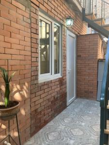 a brick wall with a door and a window at Best Value Apartment in Tbilisi Center in Tbilisi City
