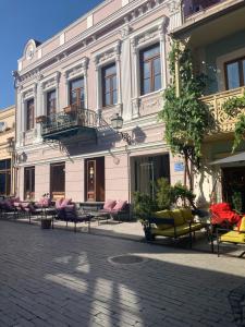 a building with a bunch of chairs in front of it at Best Value Apartment in Tbilisi Center in Tbilisi City