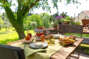 a picnic table with food and bread on it at Premignaga Natural Home in Gardone Riviera