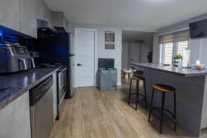 a kitchen with a counter and two bar stools at Condo in St-Roch Downtown Quebec City in Quebec City