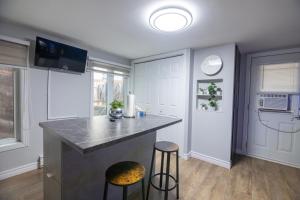 a kitchen with a counter and two stools in it at Condo in St-Roch Downtown Quebec City in Quebec City