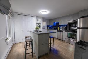 a kitchen with a counter and two bar stools at Condo in St-Roch Downtown Quebec City in Quebec City