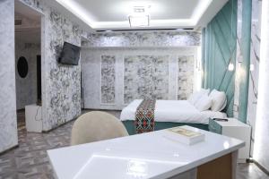a hotel room with a bed and a desk in it at Hotel Shirin in Isfara