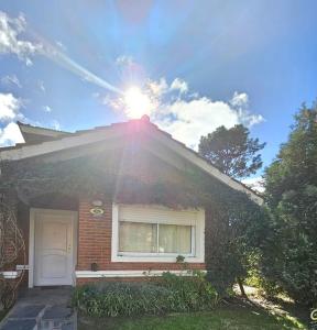 a house with the sun shining on the roof at Resolana in Valeria del Mar +18 photos