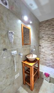 a bathroom with a sink and a shower at Resolana in Valeria del Mar +18 photos