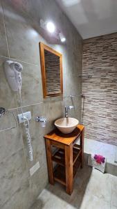 a bathroom with a sink and a shower at Resolana in Valeria del Mar