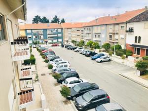 a row of cars parked in a parking lot at Cantinho da Glória in Aveiro