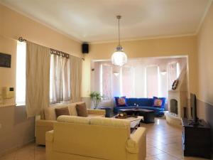 a living room with a couch and a table at Niko's art Villa in Chania in Perivólia