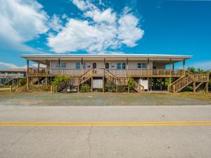 a large house with wooden decks on a street at Sunrise in Topsail Beach