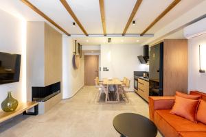 a living room with an orange couch and a table at Kave luxurystaying in Volos +48 photos