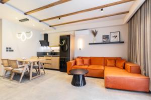 a living room with a couch and a table at Kave luxurystaying in Volos