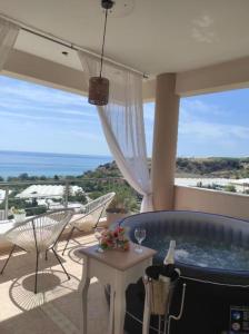 a hot tub on a patio with a view of the ocean at Grand Villa Katerina in Ierápetra