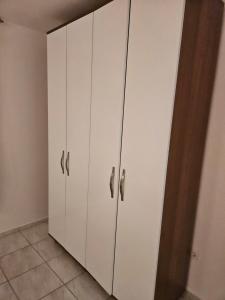a white cabinet with silver handles in a room at Villa Amela Dubrava in Bar