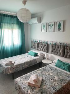 a room with three beds with towels on them at CASA PURI in Candeleda