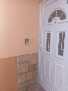 a white door in a room with a brick wall at Apartman Bagdala in Kruševac