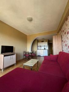 a living room with a red couch and a table at Vila SiVa in Ohrid