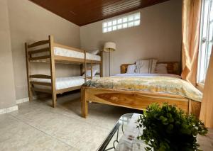 a bedroom with two bunk beds and a table at Mia Volcan in Volcán